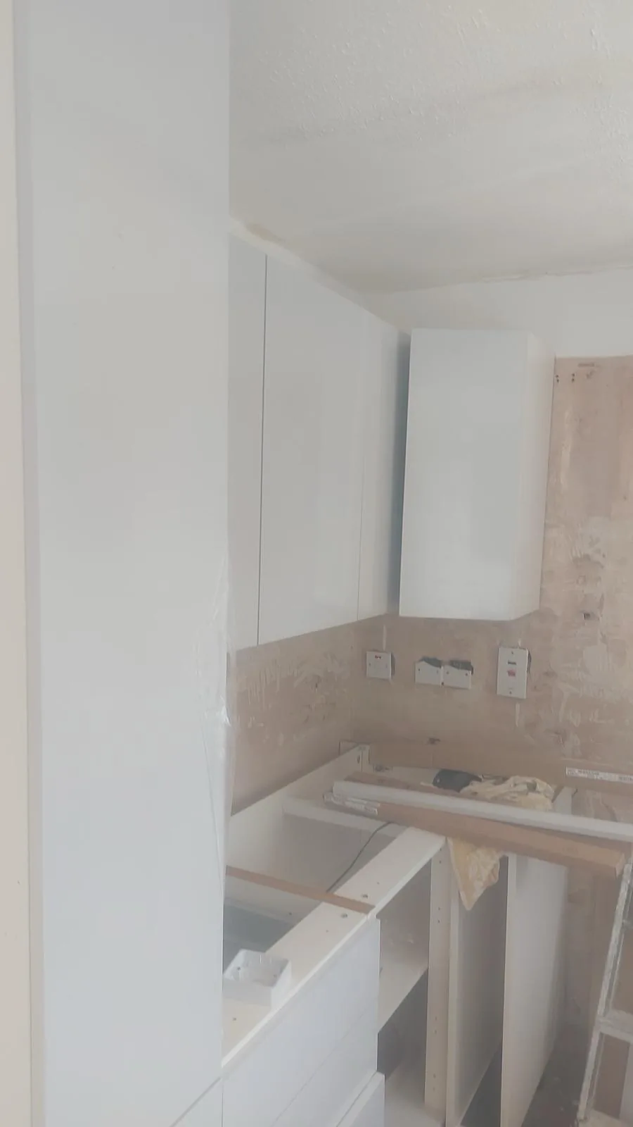 Kitchen wall and base units being fitted